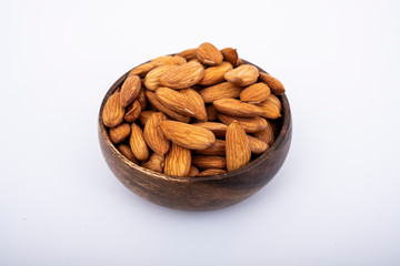 Raw almond beans on isolated white surface