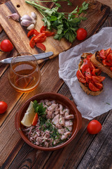Garlicy baby calamari with tomatoes on crusty bread, spanish cuisine