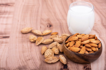 Almond nuts and almond milk on the wooden table