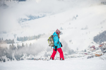 Young woman on the snowboard