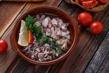 Grilled baby with garlic and lemon on wooden background