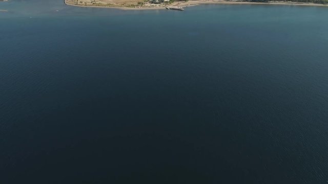 Coastline with beach and lighthouse, mountains. Aerial view: Coast sea with hotels, resorts, Subic Bay, Philippines, Luzon