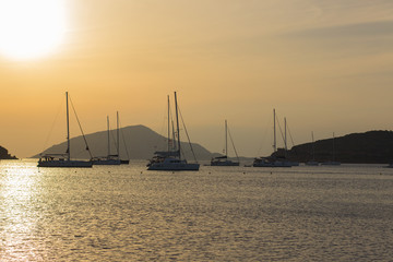 picturesque scenic beautiful sunset evening romantic landscape of dark yachts silhouettes on calm...