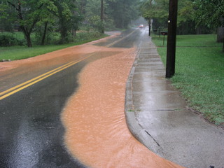 Storm water runoff on road after heavy rain in North Carolina 
