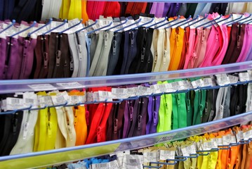 Colored zippers are arranged in beautiful rows, colorful, zipper for sewing. needlework