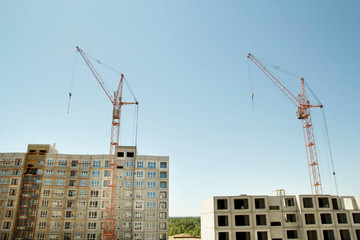 Fototapeta na wymiar Constructions cranes near building. Construction site with crane and building.