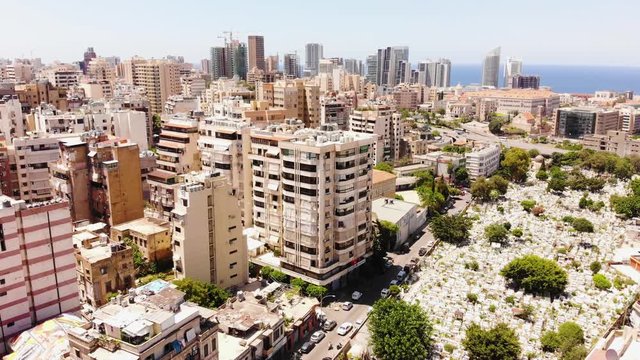 Bashoura Muslim Cemetery, Beirut, Lebanon aerial footage. Muslim cemetery in the middle of a big city with skyscrappers and cars around.Beirut skyline with skyscrappers, drone footage.