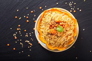 Healthy food homemade organic Quinoa Stuffed sweet dumpling squash on black slate stone with copy space