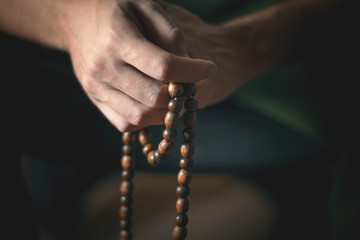 Prayer beads for meditation in men's hands. Peace, awareness and mindfulness
