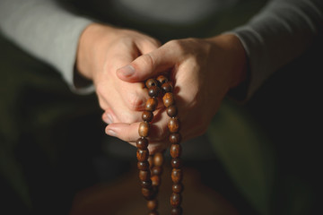 Prayer beads for meditation in men's hands. Peace, awareness and mindfulness