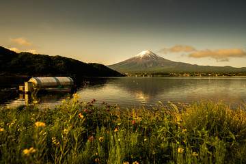Fuji mountain and Kawaguchiko lake in morning, fog flow on the air.
