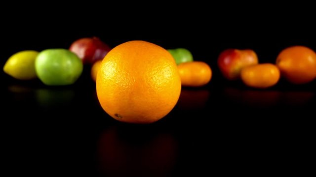 The rotating orange against the background of fruit.
