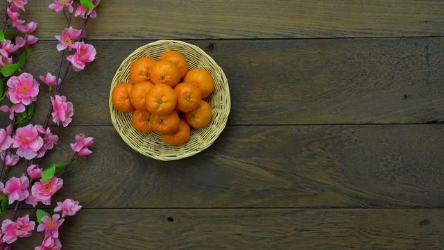 Decorations for Chinese New year festival concept background.For arrangement  red pocket money with orange and cheery blossom on rustic brown wooden at home studio office desk.
