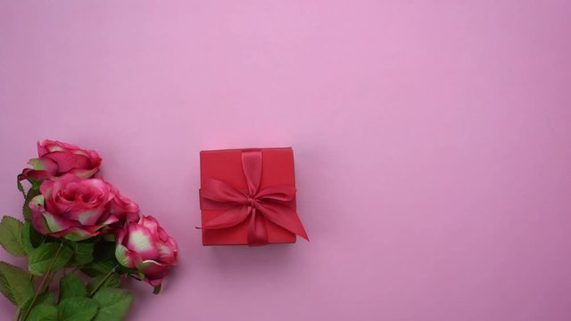 Happy valentines Day & clothing travel women background concept.During preparation & arrangement the essential  decorations for my love in festival.Gift box & colorful rose on pink paper