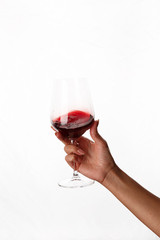 hand holding a glass of red wine