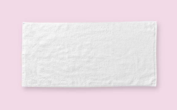 White cotton towel mock up template fabric wiper isolated on pastel pink background with clipping path, flat lay top view