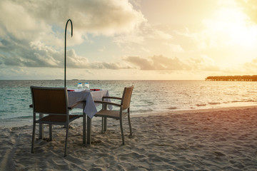 Table outdoor next to sea scenic prepare for special romantic dinner time with sunlight shading