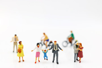 Miniature people: family and children enjoy, happy family day concept.