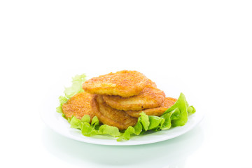 potato pancakes with lettuce leaves in a plate