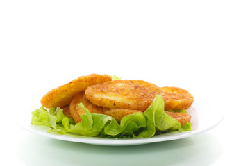 potato pancakes with lettuce leaves in a plate