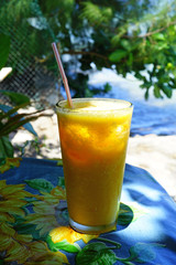 A glass of freshly pressed pineapple juice by the sea 