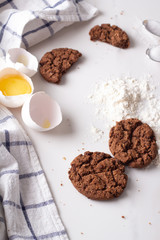 chocolate cookies and baking ingredients close-up on a white background.