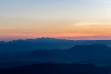 Sunrise view over mountains from a mountain peak. Mountains silhouette. Nature landscape.