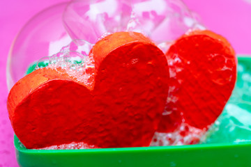 Two red hearts in soapsuds.