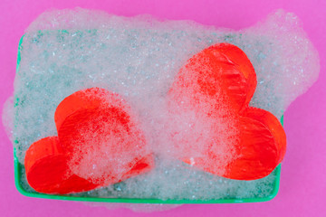 Two red hearts in soapsuds.