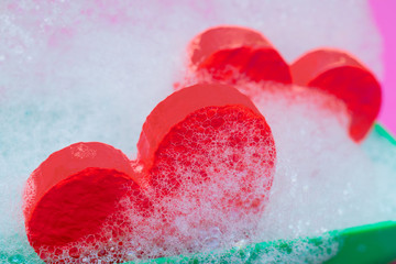 Two red hearts in soapsuds.