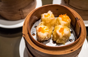 Dimsum Hagao in chinese bamboo basket traditional food in a restaurant.