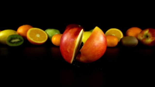 Falling of apple against the background of fruit. Slow motion.
