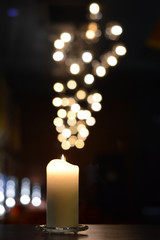 one candle with beautiful bokeh and more expressive and powerfull blurry light reflections