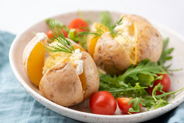 Baked potatoes with sour cream and cheese