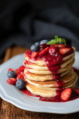 Stack of pancakes with sweet and sour berry sauce