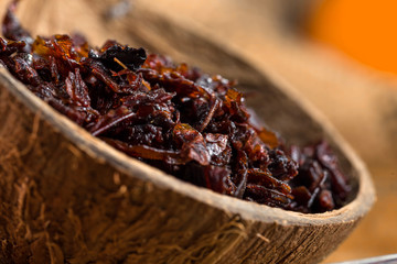 Close-up apple shisha in coconut shell. Preparation for hookah smoking