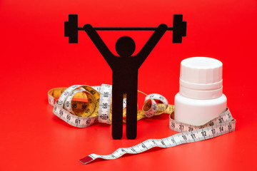 weightlifting pictogram wiht pills, tape measure