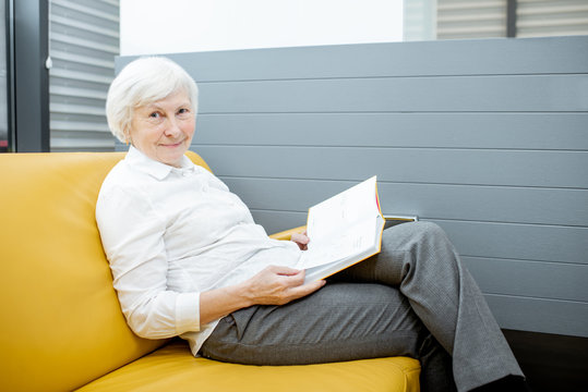 Portrait of a beautiful senior woman waiting on the couch at the hospital reception
