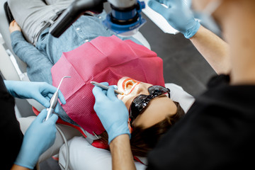 Close-up of a woman's face during the professional dental examination