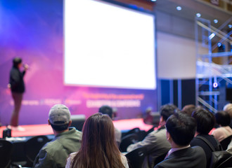 Audience Watching a Presentation. Defocused Blurred Presenter During Conference Meeting. Investor...