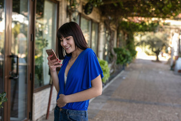 Fototapeta premium Beautiful girl enjoys her mobile phone