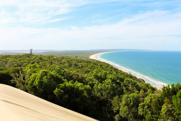 White sand dunes at Carlo Sand Blow with view of Rainbow Beach near Fraser Island during summer...