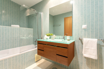 Modern bathroom with shower and washbasin for hygiene.