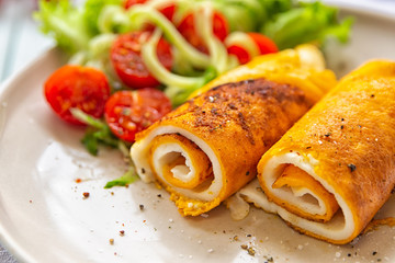 Omelet with vegetable salad. Egg breakfasts