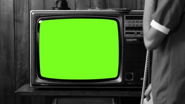 Man Using Landline Phone by Television with Green Screen, Black and White Tone