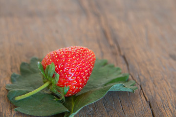 Fresh red strawberry on wood background