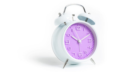 Narrow focus to clock with time 10 past 12 or 10.00 AM PM, violet clock face, on white background