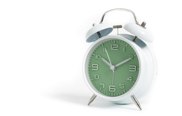 Narrow focus to clock with time 10 past 12 or 10.00 AM PM, green clock face, on white background