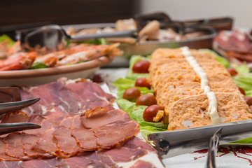 table full of plates of food in a Christmas buffet