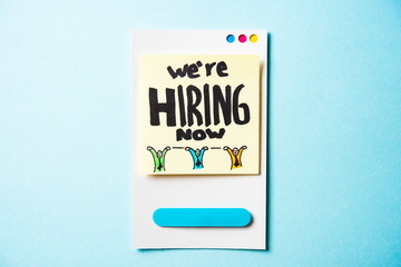 We are hiring text with paper smart phone concept on blue background. Paper card with illustration.